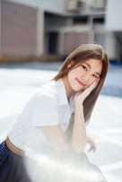 A person with her hand on her face

Description automatically generated, Picture