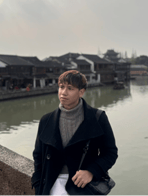 A person standing on a bridge by water

Description automatically generated, Picture