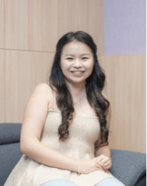 A person sitting on a couch smiling

Description automatically generated, Picture