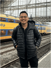 A person standing in a train station

Description automatically generated, Picture