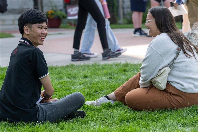 YSEALI Fellows sitting on green grass and smiling