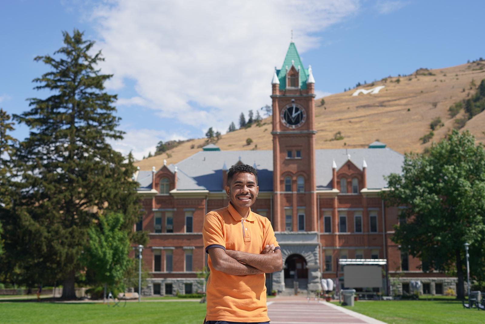 A YSEALI participant standing in front of main hall at the University of Montana